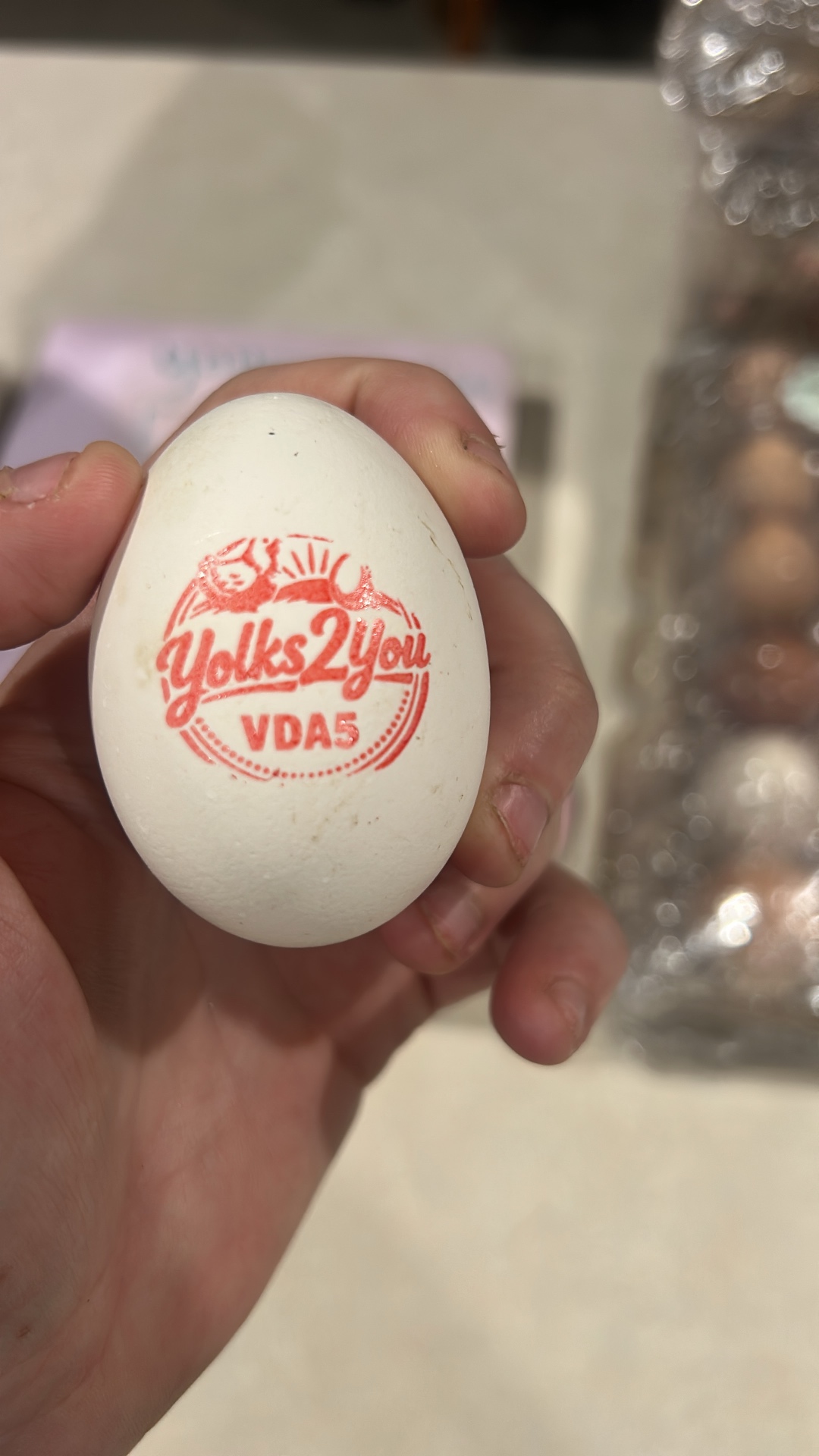 A fresh Yolks 2 You egg stamped with our farm mark
